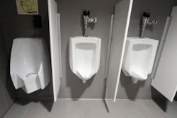A waterless urinal, left, is shown next to standard urinals at the University of Michigan engineering building, Tuesday, Jan. 24, 2017, in Ann Arbor, Mich. The waterless toilet is connected to a collection and filtration system which is part of a multi-state project researching the conversion of human urine into fertilizer.