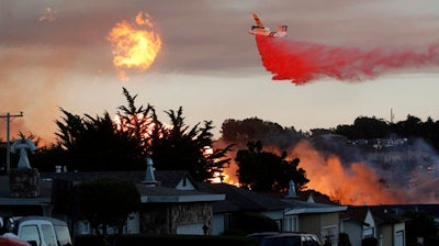In this Sept. 9, 2010, file photo, a massive fire following a pipeline explosion roars through a mostly residential neighborhood in San Bruno, Calif. Pacific Gas & Electric Co. says it is prepared to pay the maximum fine of $3 million after a jury convicted the company of deliberately violating pipeline safety regulations before a deadly natural gas pipeline explosion in the San Francisco Bay Area and then misleading investigators looking into the blast.