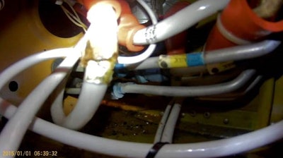 In this photo taken in an exemplar Piper PA-31T, white electrical lines are in close proximity to metal hydraulic lines. The NTSB believes this wiring may chafe and then arc, causing a fire and subsequent damage to hydraulic lines.