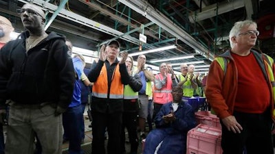 In this Tuesday, Jan. 3, 2017, file photo, Flat Rock Assembly employees clap as Ford President and CEO Mark Fields addresses the auto plant in Flat Rock, Mich.