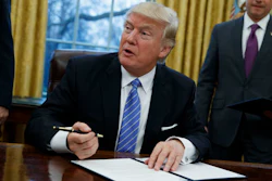 In this Monday, Jan. 23, 2017, file photo, President Donald Trump signs an executive order to withdraw the U.S. from the 12-nation Trans-Pacific Partnership trade pact agreed to under the Obama administration in the Oval Office of the White House in Washington.