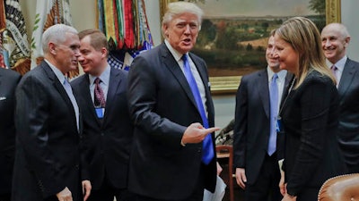 President Donald Trump gestures towards GM CEO Mary Barra, right, before the start of a meeting with automobile leaders in the Roosevelt Room of the White House in Washington, Tuesday, Jan. 24, 2017. From left are, Vice President Mike Pence, left, and Matt Blunt, president of the American Automotive Policy Council and the former governor of Missouri.