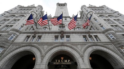 In this Dec. 21, 2106 file photo, the Trump International Hotel in Washington. An electrical subcontractor who worked on the Trump International Hotel in Washington has sued a company owned by President Donald Trump for more than $2 million, alleging it was not fully paid.