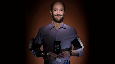 In this photo provided by Steve Fisch, Michael Snyder, professor and chair of genetics at the Stanford University School of Medicine sports wearable gadgets. Wearable gadgets gave a Snyder an early warning that he was getting sick before he ever felt any symptoms of Lyme disease.