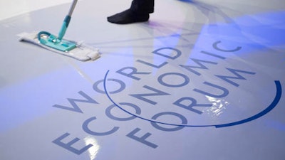 A woman cleans the stage prior to a panel session on the closing day of the 47th annual meeting of the World Economic Forum, WEF, in Davos, Switzerland, Friday, Jan. 20, 2017.