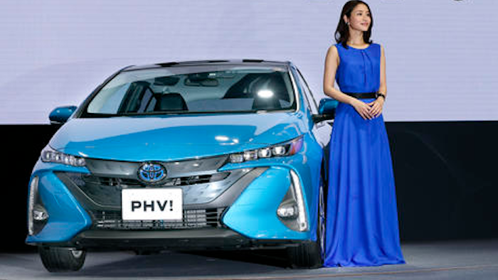 Actress Satomi Ishihara poses with a Toyota new Prius PHV during a press conference rolling out new Prius PHV plug-in hybrid in Tokyo, Wednesday, Feb. 15, 2017. Toyota has revamped its plug-in hybrid with a longer cruise range and quicker charging, including from a regular home plug, hoping it will sell better than the first model from five years ago that officials acknowledged had flopped.