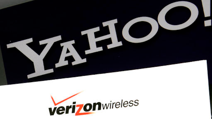 This Monday, July 25, 2016, file photo shows the Yahoo and Verizon logos on a laptop, in North Andover, Mass. Yahoo is taking a $350 million hit on its previously announced $4.8 billion sale to Verizon in a concession for security lapses that exposed personal information stored in more than 1 billion Yahoo user accounts. The revised agreement announced Tuesday, Feb. 21, 2017, eases investor worries that Verizon Communications Inc. would demand a discount of at least $1 billion or cancel the deal entirely.