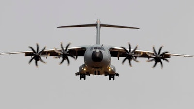 In this May 12 2015 file photo, an Airbus A400M aircraft lands in the Seville airport, Spain. Surprise new costs for the long-troubled Airbus A400M military jet sent the European planemaker's profits plunging last year despite a rise in commercial aircraft deliveries, Airbus reported Wednesday Feb. 22, 2017.