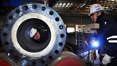 Workers make inspections at a builder of offshore platforms in Qingdao in east China's Shandong province Wednesday, Feb. 1, 2017. Chinese manufacturing expanded in January at close to its fastest pace in two years as heavy government spending and a bank lending boom helped to keep economic activity steady headed into 2017, a survey showed Wednesday.