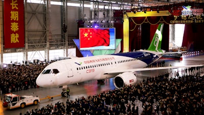 In this file photo, the first twin-engine 158-seat C919 passenger plane made by The Commercial Aircraft Corp. of China (COMAC) is pulled out of the company's hangar near the Pudong International Airport in Shanghai.