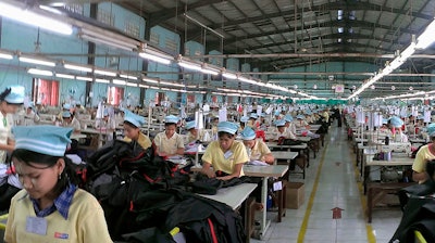 Pictured above, workers in a Myanmar garment factory. Yesterday, a dispute at a different Myanmar garment factory resulted in several staffers being held captive for hours.