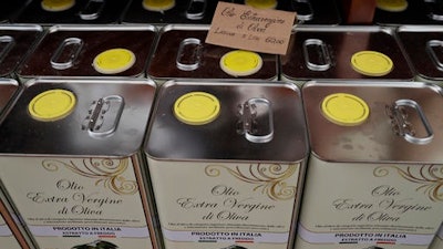 Cans of Italian extra virgin olive oil are on sale at the Iannotta family olive oil farm's shop, in Capocroce, Italy, Thursday, Feb. 16, 2017. From specialty shops in Rome to supermarkets around the world, fans of Italian olive oil are in for a surprise this year as prices are due to jump by as much as 20 percent.