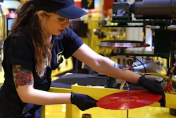 Alejandra Billegas, of Detroit, presses The White Strips 'De Stijl' album during Third Man Records Cass Corridor grand opening of the pressing plant to the public, Saturday, Feb. 25, 2017 in Detroit. Detroit-raised rocker Jack White is building on a vision to blend music and manufacturing in a part of his hometown that long inspired him. The Grammy-winning singer, songwriter, guitarist, drummer and producer is overseeing the launch of a vinyl record pressing plant in the back of his Third Man Records shop north of downtown Detroit.