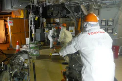 In this photo released by Tokyo Electric Power Co. (TEPCO), workers prepare to operate a remote-controlled 'cleaning' robot at Unit 2 of Fukushima Dai-ichi nuclear power plant in Okuma town, Fukushima prefecture, northeastern Japan, Thursday, Feb. 9, 2017. The 'cleaning' robot that entered one of three tsunami-wrecked Fukushima reactor containment chambers was withdrawn before completing its mission due to glitches most likely caused by high radiation.