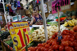 Vendor Luis Alberto Bautista arranges strawberries as he lays out fresh produce at the start of the day, in his vegetable stand in Mercado Medellin, in Mexico City, Thursday, Feb. 2, 2017. Mexico is the world’s leading exporter of refrigerators and flat-screen TVs. Cars and trucks such as the Ram 1500 crew cab, Ford Fiesta and Chevrolet Trax fill U.S. dealer lots. Mexican berries, vegetables and beef born south of the border abound at American supermarkets.