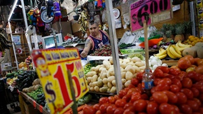 Vendor Luis Alberto Bautista arranges strawberries as he lays out fresh produce at the start of the day, in his vegetable stand in Mercado Medellin, in Mexico City, Thursday, Feb. 2, 2017. Mexico is the world’s leading exporter of refrigerators and flat-screen TVs. Cars and trucks such as the Ram 1500 crew cab, Ford Fiesta and Chevrolet Trax fill U.S. dealer lots. Mexican berries, vegetables and beef born south of the border abound at American supermarkets.