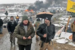 Tori Ramos, left, and Riley Cogburn, both of Albany, N.Y., leave as opponents of the Dakota Access pipeline leave their main protest camp Wednesday, Feb. 22, 2017, near Cannon Ball, N.D. Most of the pipeline opponents abandoned their protest camp Wednesday ahead of a government deadline to get off the federal land, and authorities moved to arrest some who defied the order in a final show of dissent.