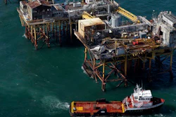 In this Friday, Nov. 16, 2012, file aerial photo, a supply vessel moves near Black Elk Energy's oil platform damaged by an explosion and fire in the Gulf of Mexico about 17 miles from Grand Isle, La. An oil industry services company will pay $9.5 million in penalties for Gulf of Mexico safety violations and for pollution from the 2012 offshore platform fire that killed three workers. The penalties against Houston-based Wood Group PSN were announced Thursday, Feb. 23, 2017, by the U.S. Justice Department in Washington and U.S. attorneys in New Orleans and Lafayette, Louisiana, where civil and criminal cases have been playing out.