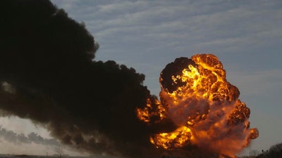 In this Dec. 30, 2013 file photo, a fireball goes up at the site of an oil train derailment in Casselton, N.D. The National Transportation Safety Board is set to release the cause of the 2013 oil train derailment in eastern North Dakota. The accident happened when a train carrying soybeans derailed in front of an oil tanker train near the small town of Casselton. It caused a series of explosions and the evacuation of about 1,400 residents, but no one was hurt.