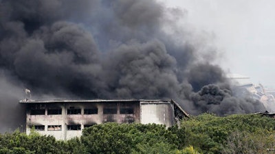 Smoke rises from a huge fire at the House Technology Industries (HTI) factory inside the Export Processing Zone Authority for more than twenty hours, Thursday, Feb. 2, 2017 in General Trias township, Cavite province south of Manila, Philippines.