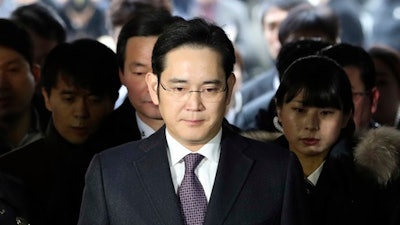 In this Jan. 18, 2017, file photo, Lee Jae-yong, front, a vice chairman of Samsung Electronics Co. arrives for the hearing at the Seoul Central District Court in Seoul, South Korea. South Korean prosecutors say they will indict Lee on bribery, embezzlement and other charges linked to a political scandal that has toppled President Park Geun-hye.