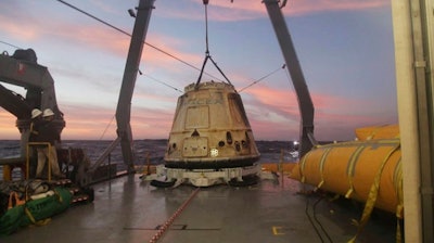 In this Tuesday, Feb. 10, 2015 file photo made available by SpaceX, their Dragon capsule sits aboard a ship in the Pacific Ocean west of Mexico's Baja Peninsula after returning from the International Space Station, carrying about 3,700 lbs of cargo for NASA. SpaceX announced Monday, Feb. 27, 2017 that it would send two paying customers to the moon next year on a private flight aboard its Dragon capsule. The company said the unnamed customers have paid “a significant deposit” for the moon trip.