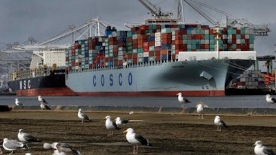 In this Friday, Feb. 3, 2017, file photo, the Chinese container ship Cosco Glory waits to be unloaded at the Port of Oakland in Oakland, Calif. According to information released Tuesday, Feb. 7, 2017, by the Commerce Department, the U.S. trade deficit narrowed slightly in December 2016, but the improvement wasn't enough to keep the deficit for the entire year from rising to the highest level since 2012. That should provide fuel for President Donald Trump's contention that America needs a tougher approach to trade.