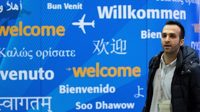 Iranian bioengineering researcher Nima Enayati walks out of a gate after arriving at John F. Kennedy International Airport in New York, Sunday, Feb. 5, 2017. The Ph.D. candidate at a university in Milan, was prevented from boarding a flight to the U.S. on Jan. 30. He had a visa to conduct research on robotic surgery at Stanford University in California.