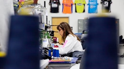 Marlene Kramer works at a sewing machine for a custom sportswear company in Prairie du Chien, Wis., Thursday, Jan. 19, 2017. Kramer said she's glad that the Affordable Care Act has helped millions get insurance and saved lives, but it hasn't helped hers. It's cheaper for them to pay the penalty of $2,000 and forgo health insurance, and they pray they don't get sick before Trump, she hopes, keeps his promise to replace the law with something better.