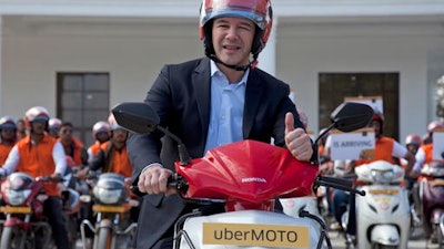 In this Dec. 13, 2016, file photo, Uber CEO Travis Kalanick, poses during the launch of its bike-sharing product, uberMOTO, in Hyderabad, India. Kalanick has quit President Donald Trump's council of business leaders, according to an internal memo obtained by The Associated Press.