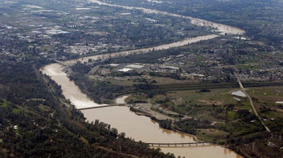 The water from the Feather River flows through Oroville, Calif., Monday, Feb. 13, 2017. Water levels at Lake Oroville, which feeds the river are continuing to drop, stopping water from spilling over the spillway. Thousands of Northern California residents were asked to evacuate their homes Sunday evening after authorities warned the emergency spillway of the Oroville Dam could fail at any time unleashing uncontrolled flood waters on towns below.
