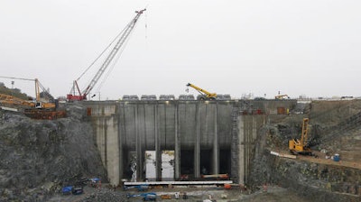 In this Feb. 6, 2015, file photo the auxiliary spillway is under construction at Folsom Dam, in Folsom, Calif. Twelve years ago, widespread destruction from Hurricane Katrina on the Gulf Coast helped compel federal engineers to spend nearly $1 billion constructing the auxiliary spillway at Folsom Dam, scheduled to be completed in 2017.