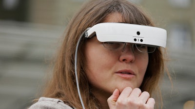 In this photo taken Thursday, Feb. 2, 2017, Yvonne Felix wears eSight electronic glasses and looks around Union Square during a visit to San Francisco. The glasses enable the legally blind to see. Felix was diagnosed with Stargardt’s disease after being hit by a car at the age of seven.