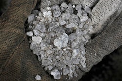 In this Feb. 1, 2017 photo, a handful of snow-melting road salt mined by the American Rock Salt Co. is photographed at a service station in Williamsville, N.Y.