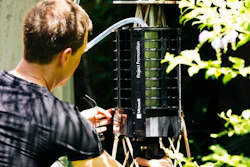 In this photo provided by Microsoft, Microsoft researcher Ethan Jackson sets up a trap for mosquitoes in Harris County, Texas in 2016. A new high-tech version trap is promising to catch the bloodsuckers while letting friendlier insects escape, and even record the exact weather conditions when different species emerge to bite.