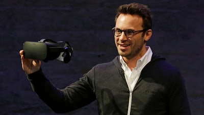 In this Thursday, June 11, 2015, file photo, Oculus CEO Brendan Iribe holds up the Rift virtual reality headset during a news conference in San Francisco. In a verdict reached Wednesday, Feb. 1, 2017, Facebook's virtual-reality subsidiary and two of its founders, Iribe and Palmer Luckey, are facing a sobering reality after a jury hit them with a $500 million bill for infringing on the rights of a video-game maker.