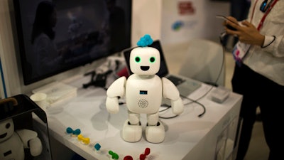 Pibo robot, whose main purpose is getting you and your loved ones sharing your daily life again, receives instructions from her owner, at the Four Years From Now (FYFN) show, a sidebar event of Mobile World Congress in Barcelona, Spain, Monday, Feb. 27, 2017.