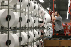 In this Friday, Oct. 21, 2016, file photo, a worker loads spools of thread at the Repreve Bottle Processing Center, part of the Unifi textile company, in Yadkinville, N.C. The Institute for Supply Management, a trade group of purchasing managers, issues its index of manufacturing activity for January, on Wednesday, Feb. 1, 2017.