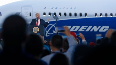 President Donald Trump speaks to Boeing employees, Friday, Feb. 17, 2017, in the final assembly building at Boeing South Carolina in North Charleston, S.C. The president visited the plant where Boeing rolled out the first 787-10 Dreamliner aircraft from its assembly line seen in back.