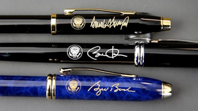 In this Tuesday, Feb. 14, 2017, photo A.T. Cross Co. custom-made pens designed for President Donald Trump, top, former President Barack Obama, center, and former President George W. Bush, below, featuring their signatures and presidential seals, rest side by side at the Cross Company Store in Providence, R.I.