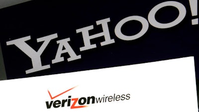This Monday, July 25, 2016, file photo shows the Yahoo and Verizon logos on a laptop, in North Andover, Mass. Yahoo is taking a $350 million hit on its previously announced $4.8 billion sale to Verizon in a concession for security lapses that exposed personal information stored in more than 1 billion Yahoo user accounts. The revised agreement announced Tuesday, Feb. 21, 2017, eases investor worries that Verizon Communications Inc. would demand a discount of at least $1 billion or cancel the deal entirely.