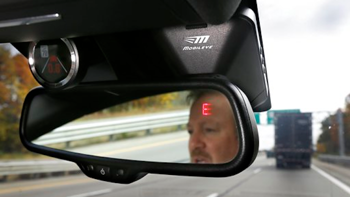 This Wednesday, Oct. 14, 2015, file photo, shows a Mobileye camera system that can be installed in your car to monitor speed limits and warn drivers of potential collisions, mounted behind the rearview mirror during a demonstration of the system, in Ann Arbor, Mich. Intel is buying Mobileye in a deal announced Monday, March 13, 2017, and valued at about $14.09 billion, the latest push by a major tech company into autonomous vehicles that could change the way traffic moves globally.
