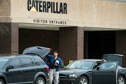 Federal officials gather at their vehicles as they continue to execute a search warrant at the Caterpillar, Inc. facility in Morton, Ill., one of three Caterpillar facilities they are searching in the Tri-County area Thursday, March 2, 2017.