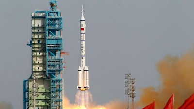 In this June 16, 2012, file photo, the Shenzhou 9 spacecraft rocket launches from the Jiuquan Satellite Launch Center in Jiuquan, China. State media say China is developing an advanced new spaceship capable of both flying in low-Earth orbit and landing on the moon. The newspaper Science and Technology Daily cited spaceship engineer Zhang Bainian as saying the new craft would be recoverable and have room for multiple astronauts.