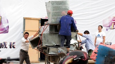 In this Aug. 22, 2016 file photo, workers remove air ducts made from aluminum sheet metal in Beijing, China. American aluminum producers have filed a complaint on Thursday, March 9, 2017 accusing Chinese smelters of exporting at improperly low prices in the first case of its kind for the administration of President Donald Trump.