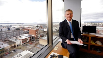 In this Feb. 16, 2017, file photo, Everett Mayor Ray Stephanson sits in his corner office overlooking downtown Everett, Wash. Stephanson is suing pharmaceutical giant Purdue Pharma, becoming the first city to try to hold the maker of OxyContin accountable for damages to his community. Connecticut-based Purdue Pharma argued in court documents filed Monday, March 20, 2017, there is no legal basis for such a lawsuit.
