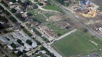 In this April 18, 2013 aerial file photo, the remains of a nursing home, left, apartment complex, center, and fertilizer plant, right, destroyed by an explosion at a fertilizer plant in West, Texas. The Trump administration is delaying a new rule tightening safety requirements for companies that store large quantities of dangerous chemicals. Environmental Protection Agency (EPA) Administrator Scott Pruitt has delayed the effective date of the Obama-era rule until June.