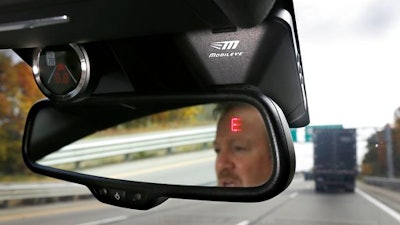 This Wednesday, Oct. 14, 2015, file photo, shows a Mobileye camera system that can be installed in your car to monitor speed limits and warn drivers of potential collisions, mounted behind the rearview mirror during a demonstration of the system, in Ann Arbor, Mich. Intel is buying Mobileye in a deal announced Monday, March 13, 2017, and valued at about $14.09 billion, the latest push by a major tech company into autonomous vehicles that could change the way traffic moves globally.