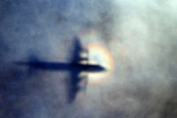 FILE - In this March 31, 2014 file photo, the shadow of a Royal New Zealand Air Force P3 Orion is seen on low level cloud while the aircraft searches for missing Malaysia Airlines Flight MH370 in the southern Indian Ocean, near the coast of Western Australia. A series of catastrophic electrical and other failures may have led to the crash of Flight 370 over the Indian Ocean, according to a lawsuit filed Friday, March 3, 2017, in the U.S. on behalf of the families of 44 people on board the still missing plane.