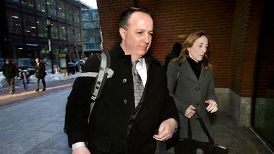 Barry Cadden, center, arrives at the federal courthouse, Thursday, March 16, 2017, in Boston, before scheduled closing arguments in his trial. Cadden, a former pharmacy executive and the president of New England Compounding Center, is charged with causing the deaths in 2012 of 25 people who received tainted steroids manufactured by the pharmacy.